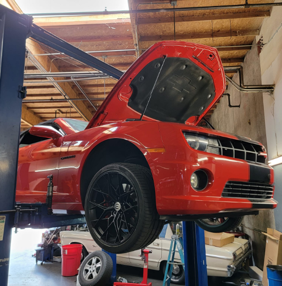 Red Mustang on lift 